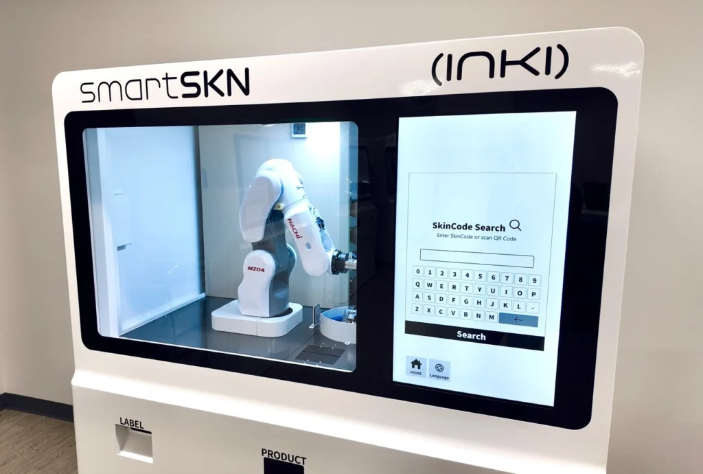 SmartSKN robotic machine with touchscreen interface for personalized skincare product creation by Inki.