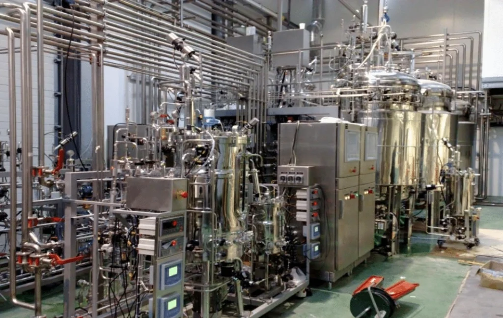 Industrial stainless steel fermentation equipment and control systems in a large-scale bioprocessing facility.