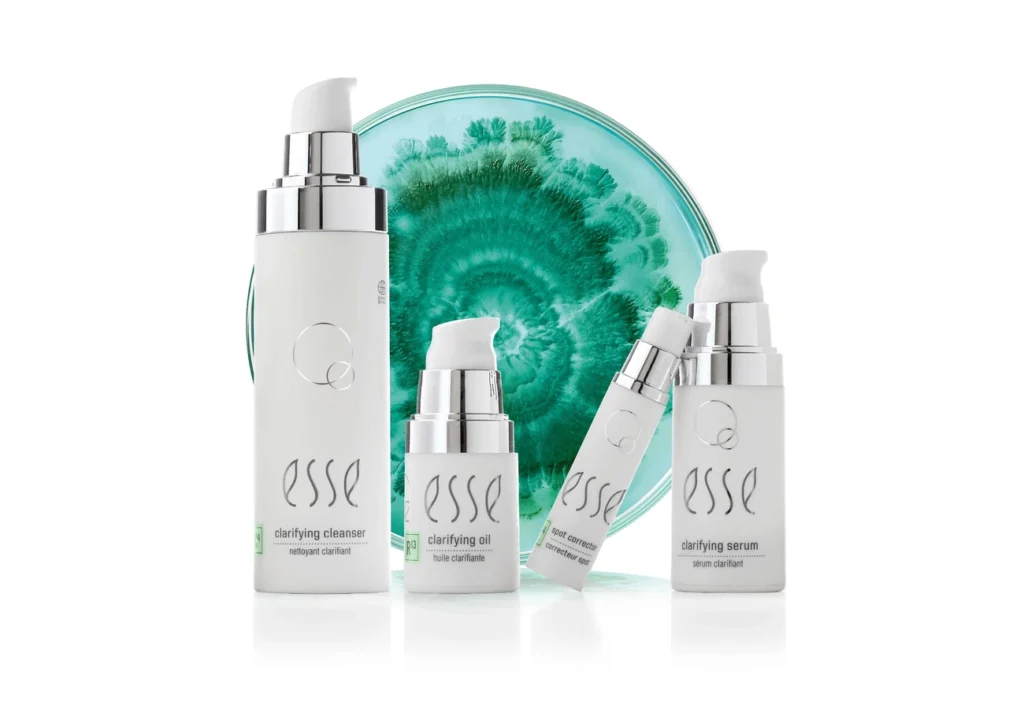 Probiotic Cosmetics: 7 Proven Benefits for a Superior Skin Microbiome 5 Probiotic skincare products including cleanser, oil, spot corrector, and serum for acne treatment with a green petri dish background.
